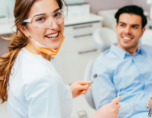 Dentist and patient smiling, working with a trusted dental lab partner for quality restorations